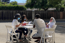 A group of people sitting around a table.