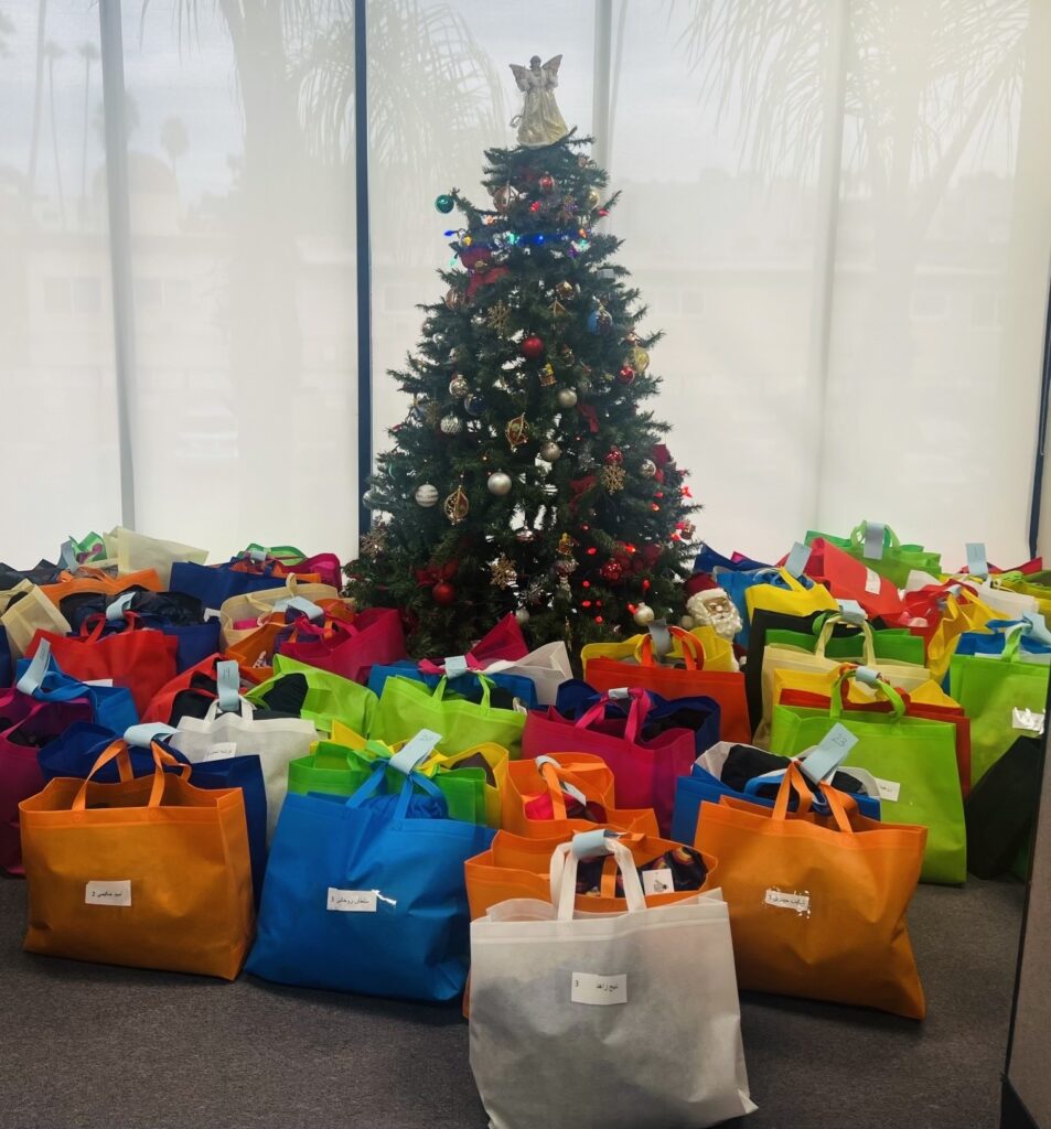 A group of bags sitting in front of a christmas tree.