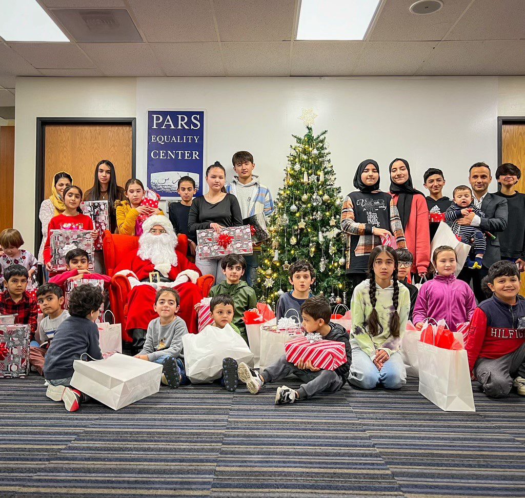 A group of children posing for a picture with santa claus.