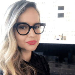 A woman with glasses and red lipstick.