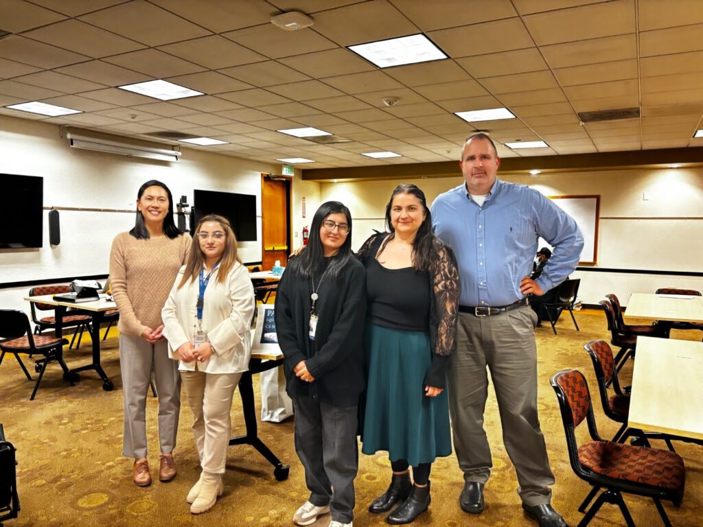 A group of people standing in a room.